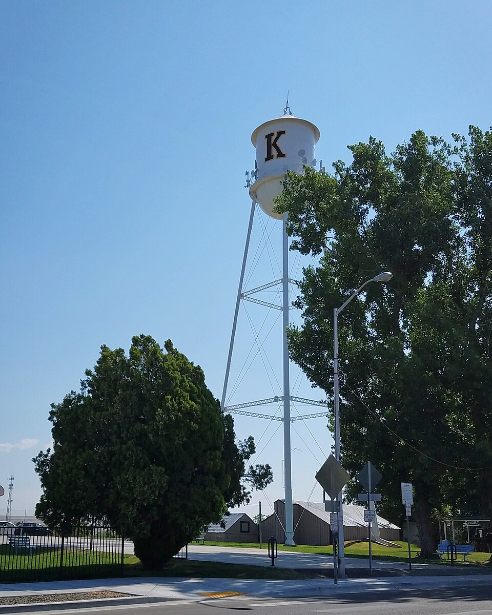 Kuna water tower with a large K above trees in Kuna, Idaho